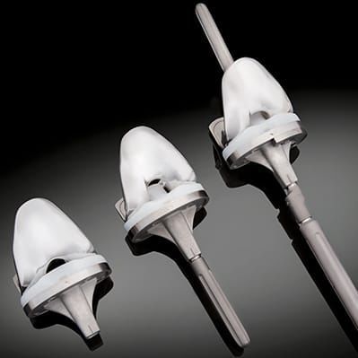Prótesis de rodilla tricompartimental - Exactech - de revisión / de platillo móvil / cementada